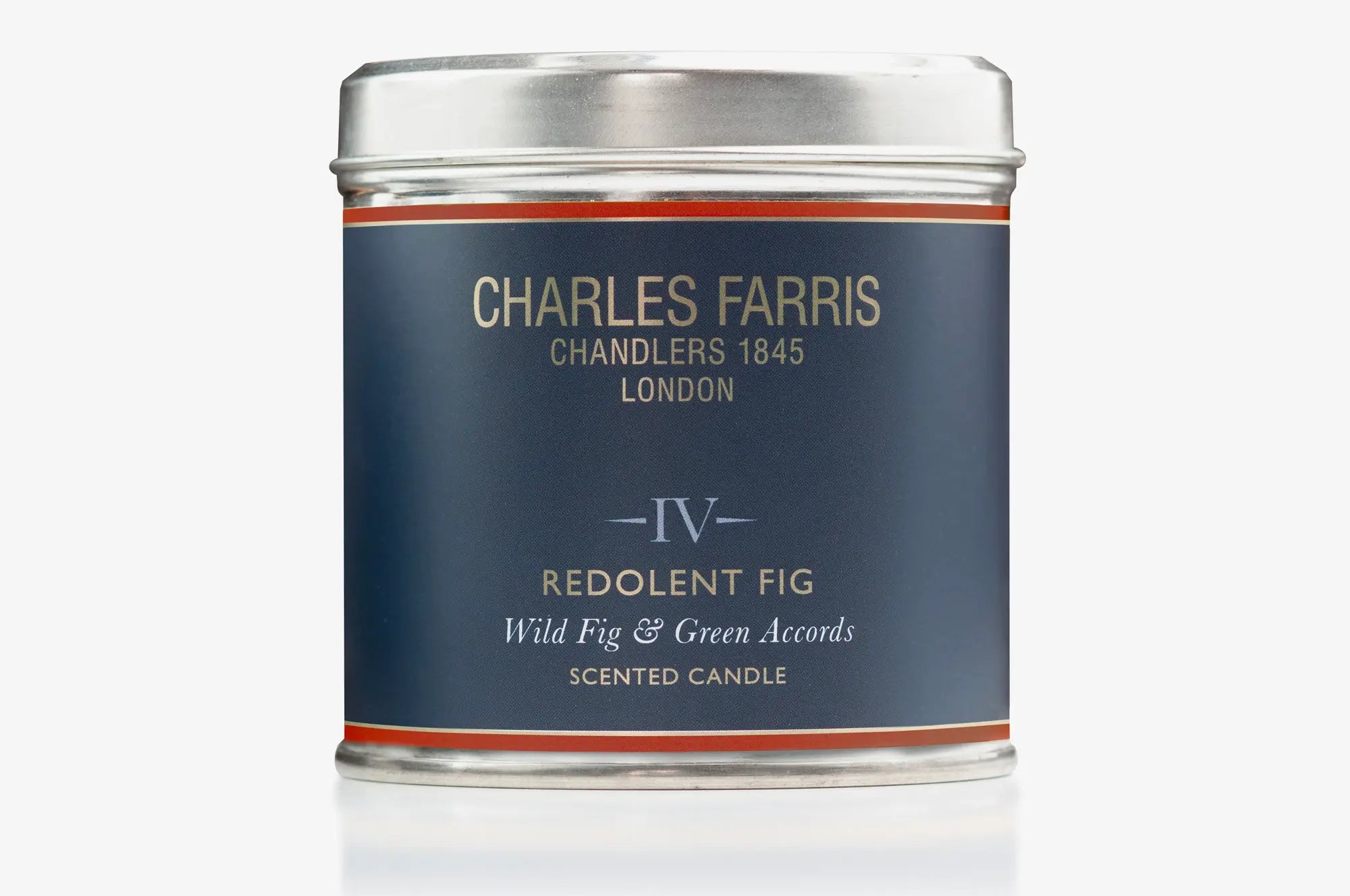 Scented candle tin labeled 'IV Redolent Fig' by Charles Farris on a white background