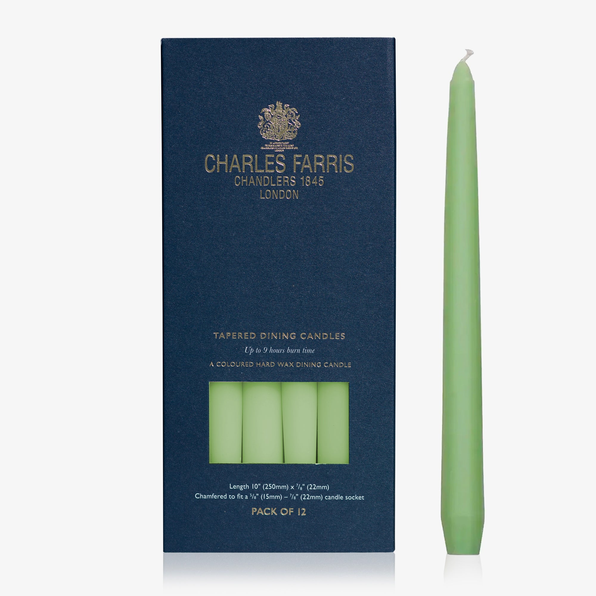 Green taper candle next to its packaging with 'Charles Farris' branding on a white background