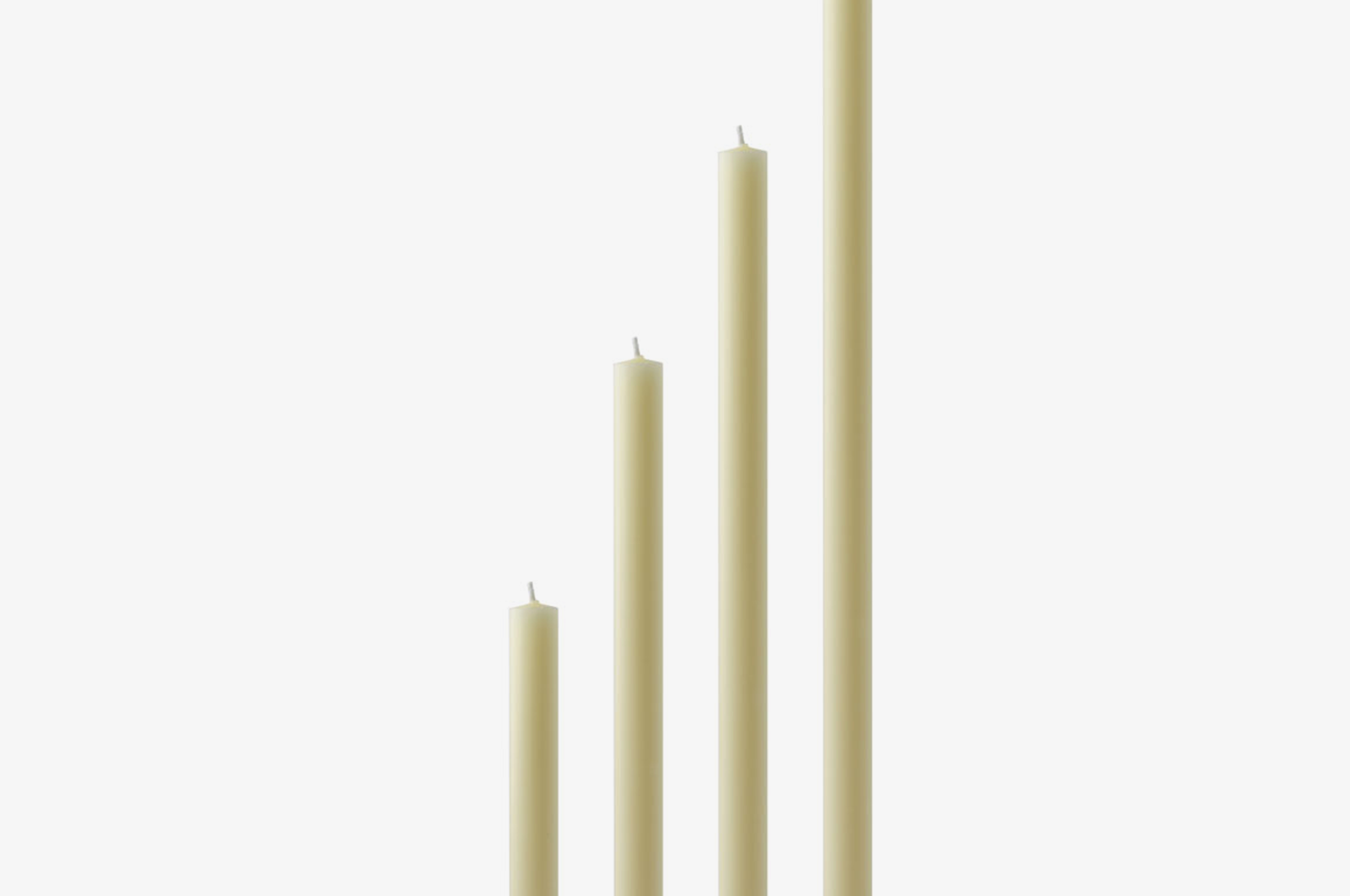 Set of four ivory beeswax candles of varying lengths on a white background