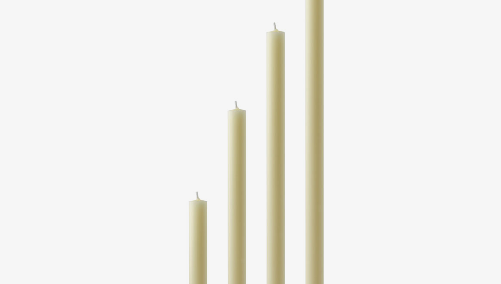 Set of four ivory beeswax candles of varying lengths on a white background