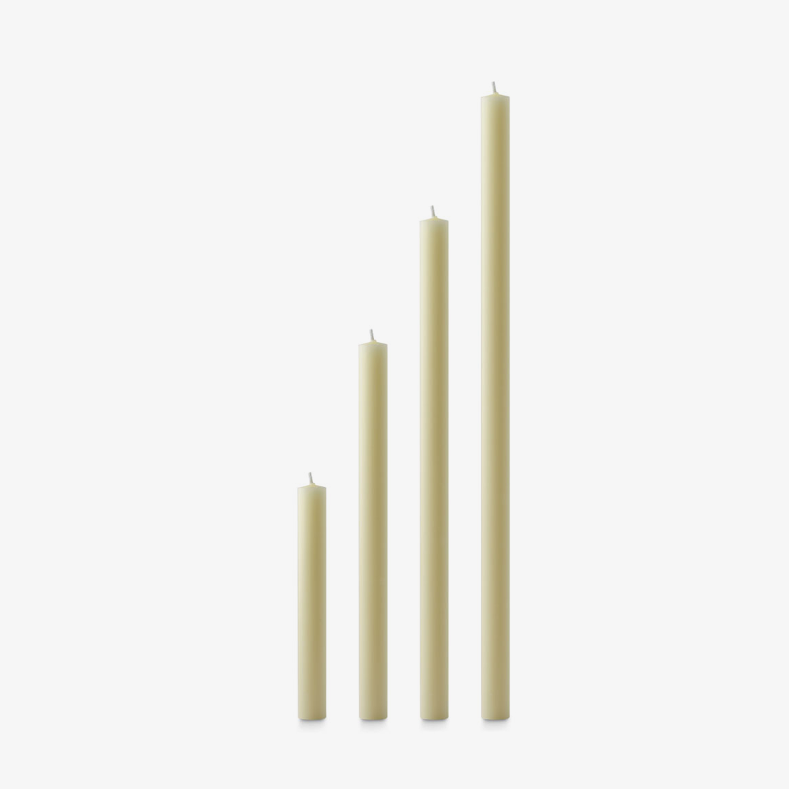 Set of four ivory beeswax candles of varying lengths on a white background