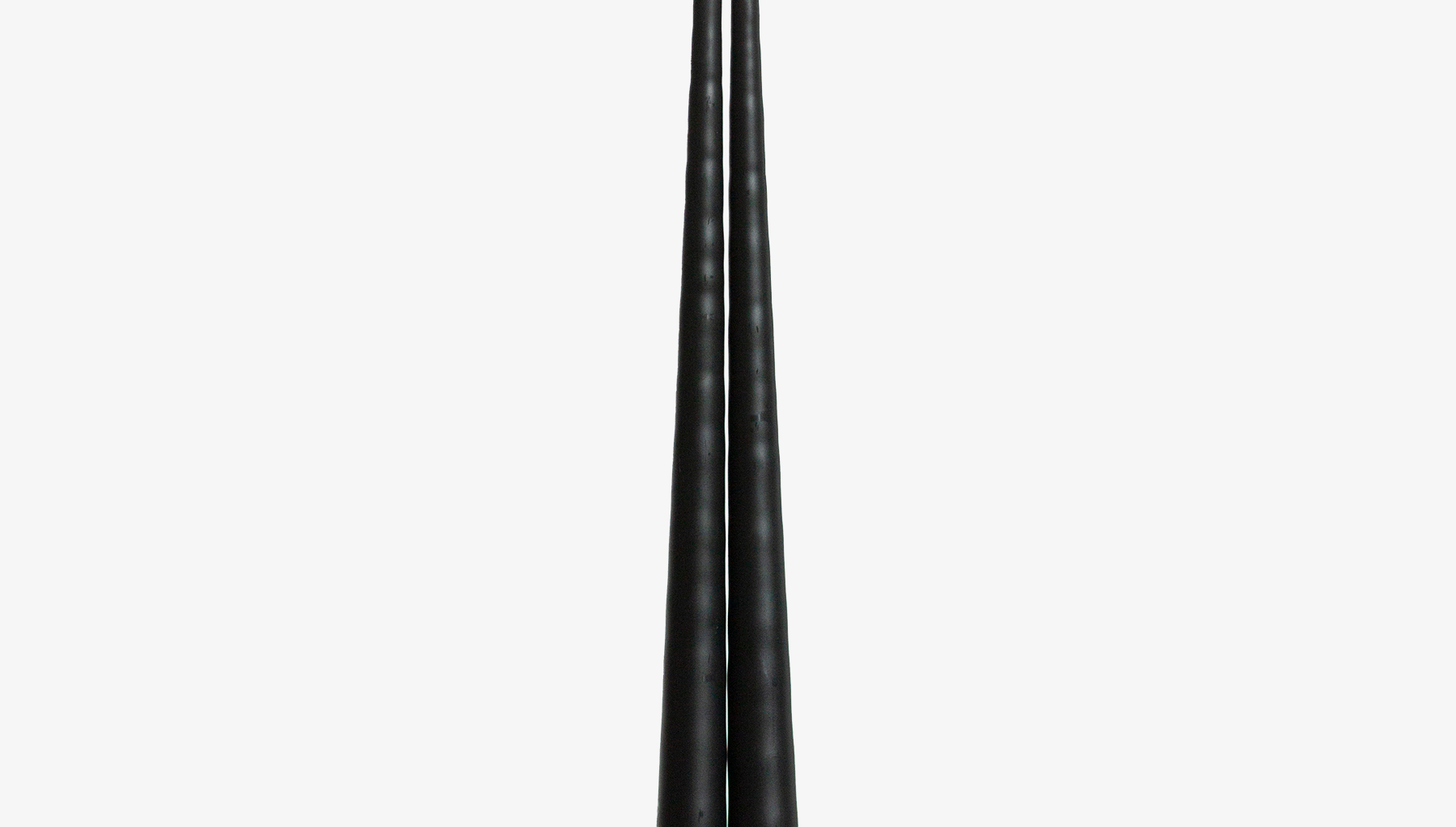 Two black candles on a white background