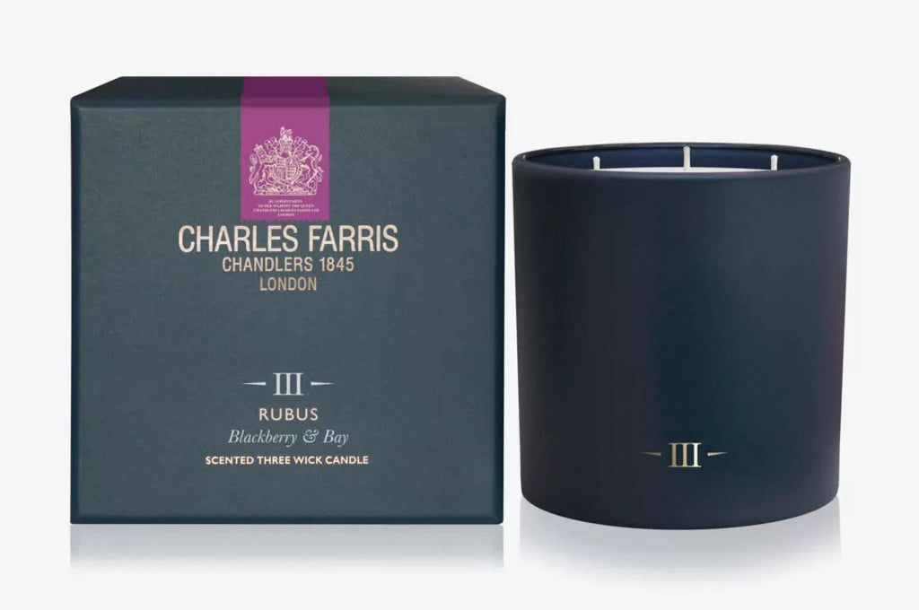 Dark blue candle with 'Charles Farris' packaging on a white background