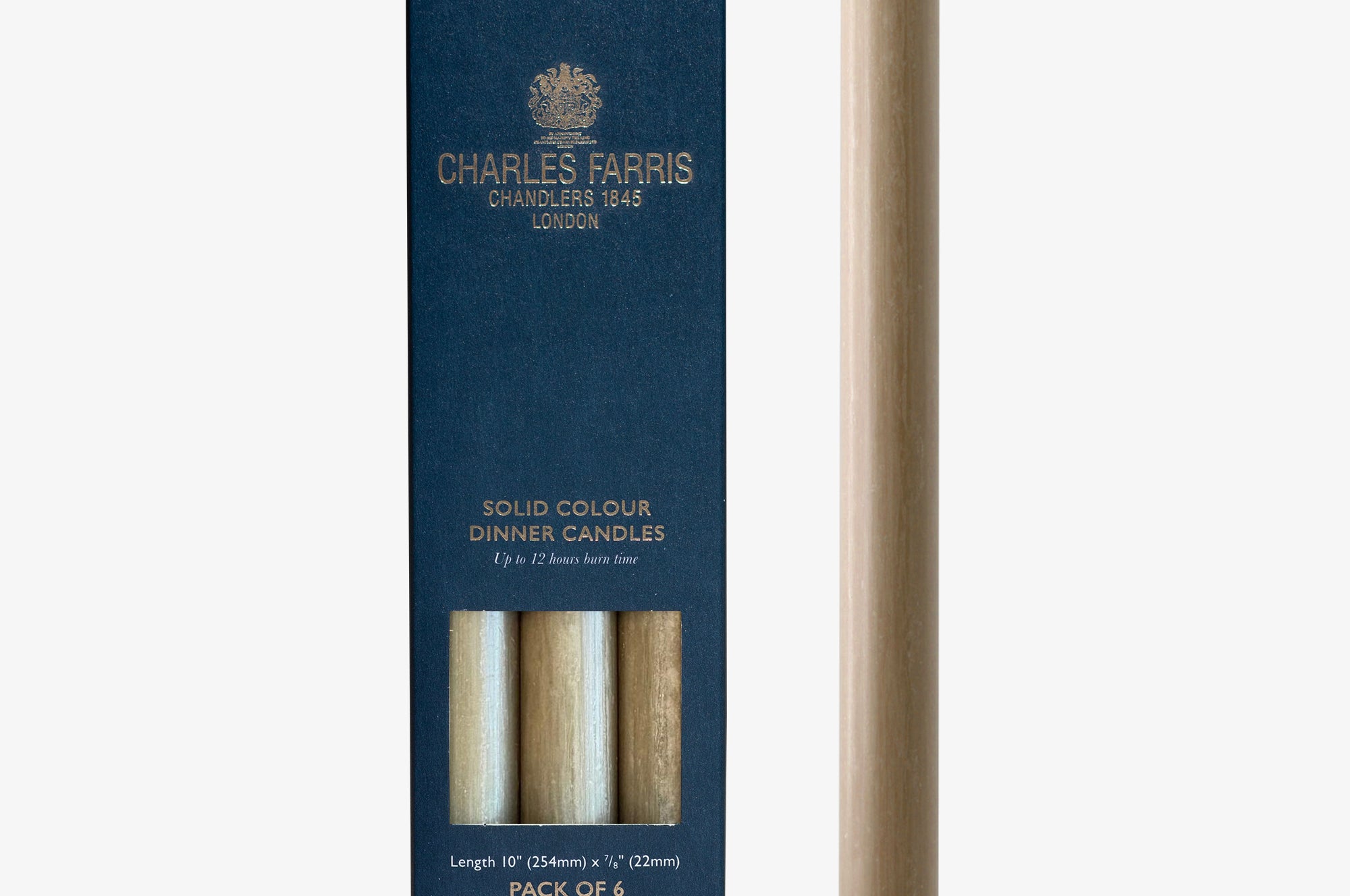 Clay colour dinner candle next to its packaging with 'Charles Farris' branding on a white background