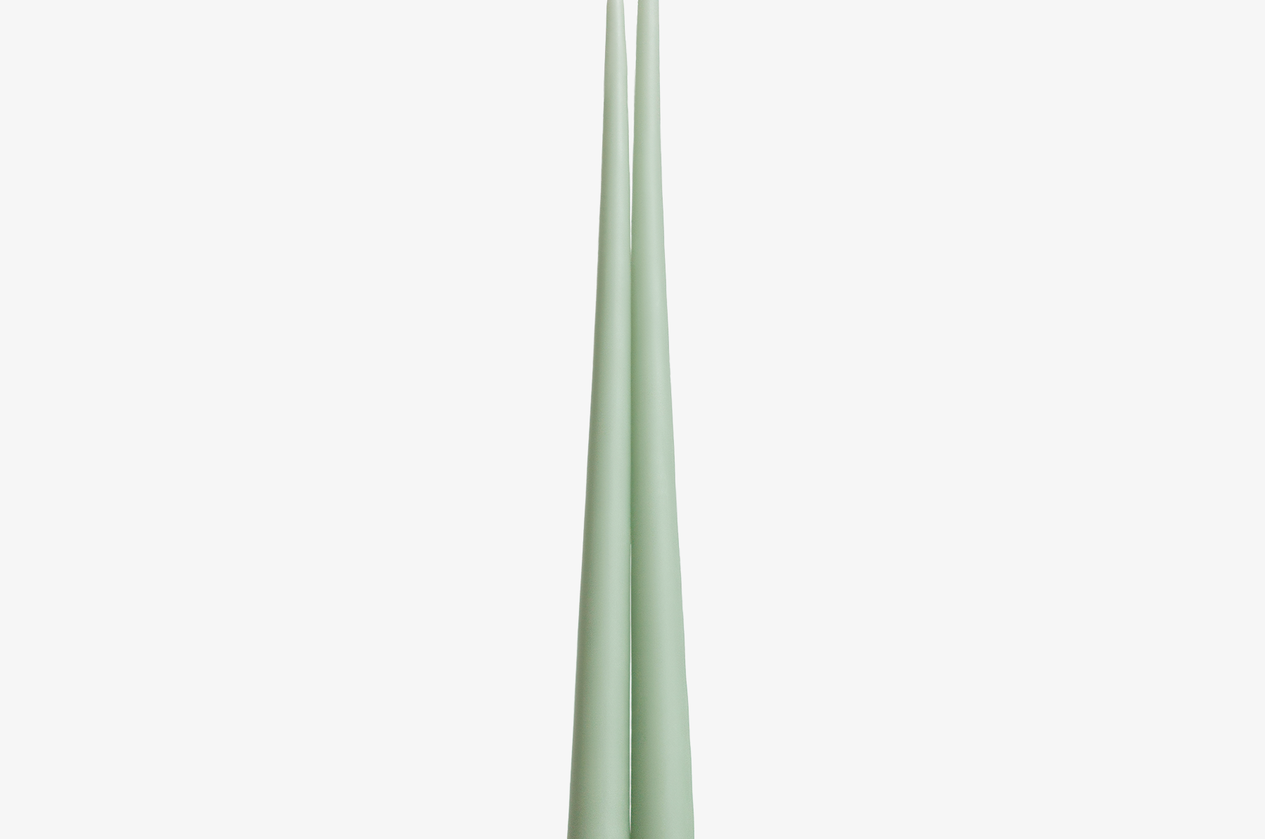 Two green candles on a white background