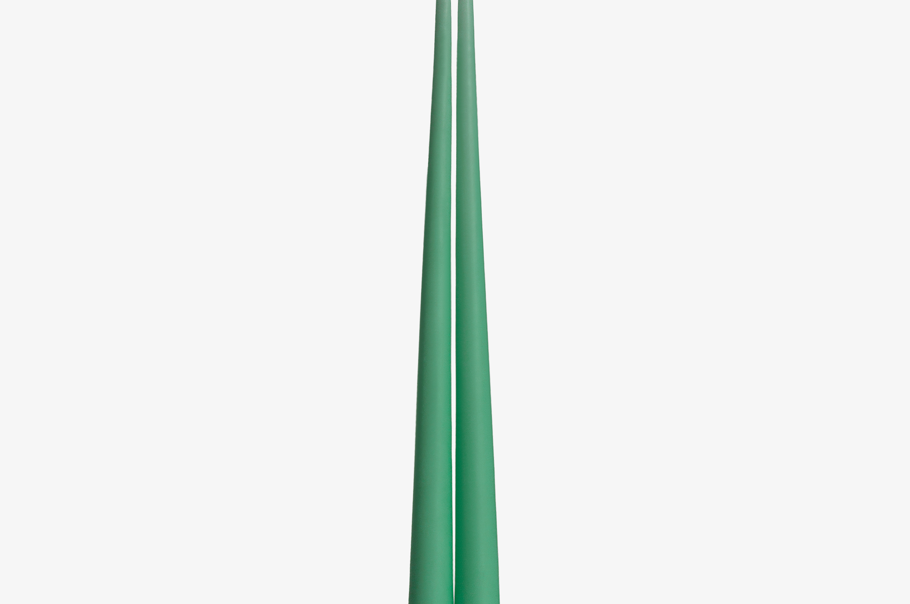 Two green candles on a white background