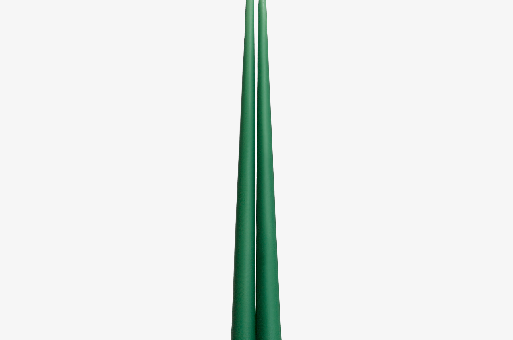 Two green candles on a white background