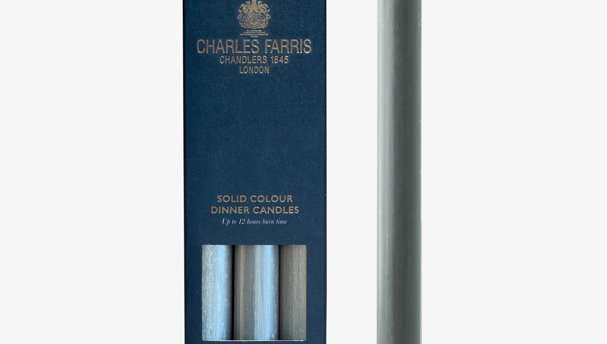 Solid colour flint grey dinner candle with packaging by Charles Farris on a white background