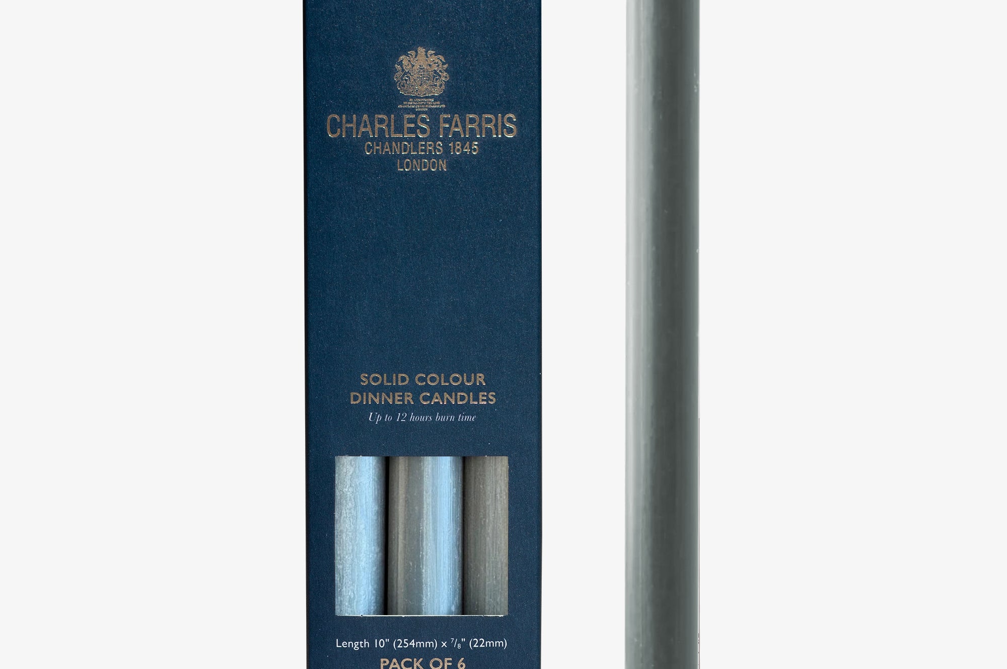 Solid colour flint grey dinner candle with packaging by Charles Farris on a white background