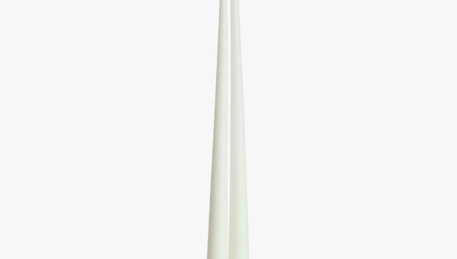 Two ivory white candles on a white background