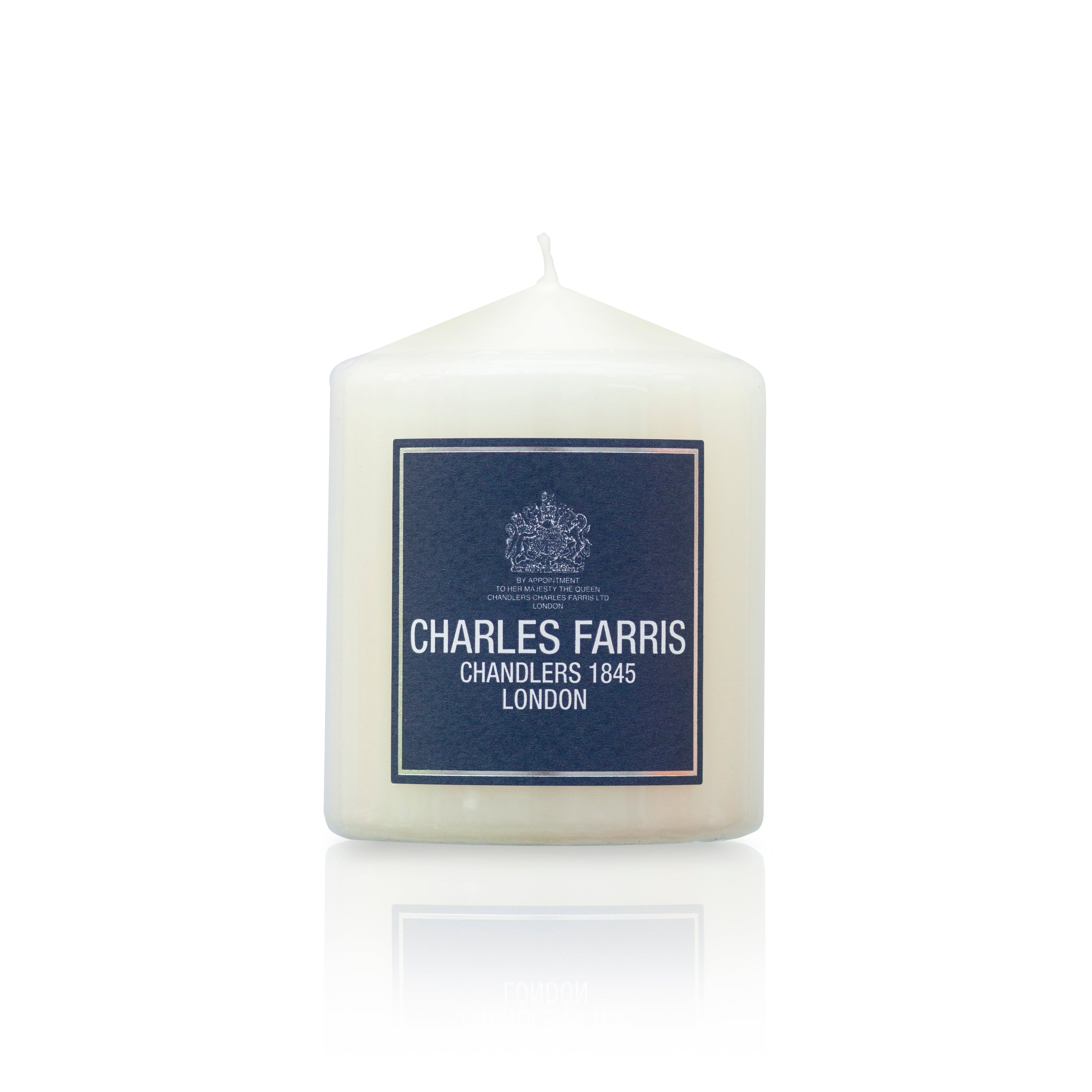 White candle with a blue label featuring 'Charles Farris' on a white background