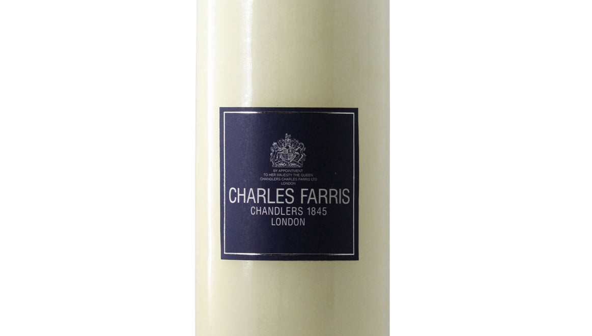 Ivory candle with a label on a white background