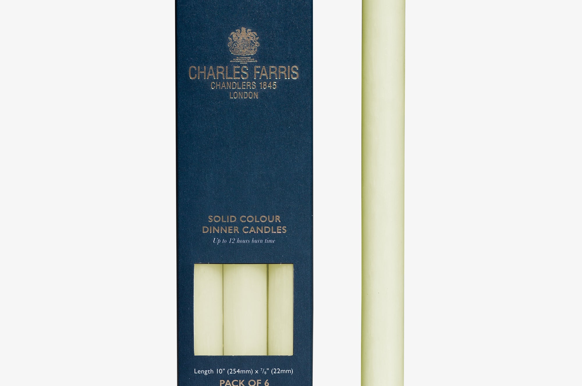 Ivory dinner candle next to its packaging with 'Charles Farris' branding on a white background