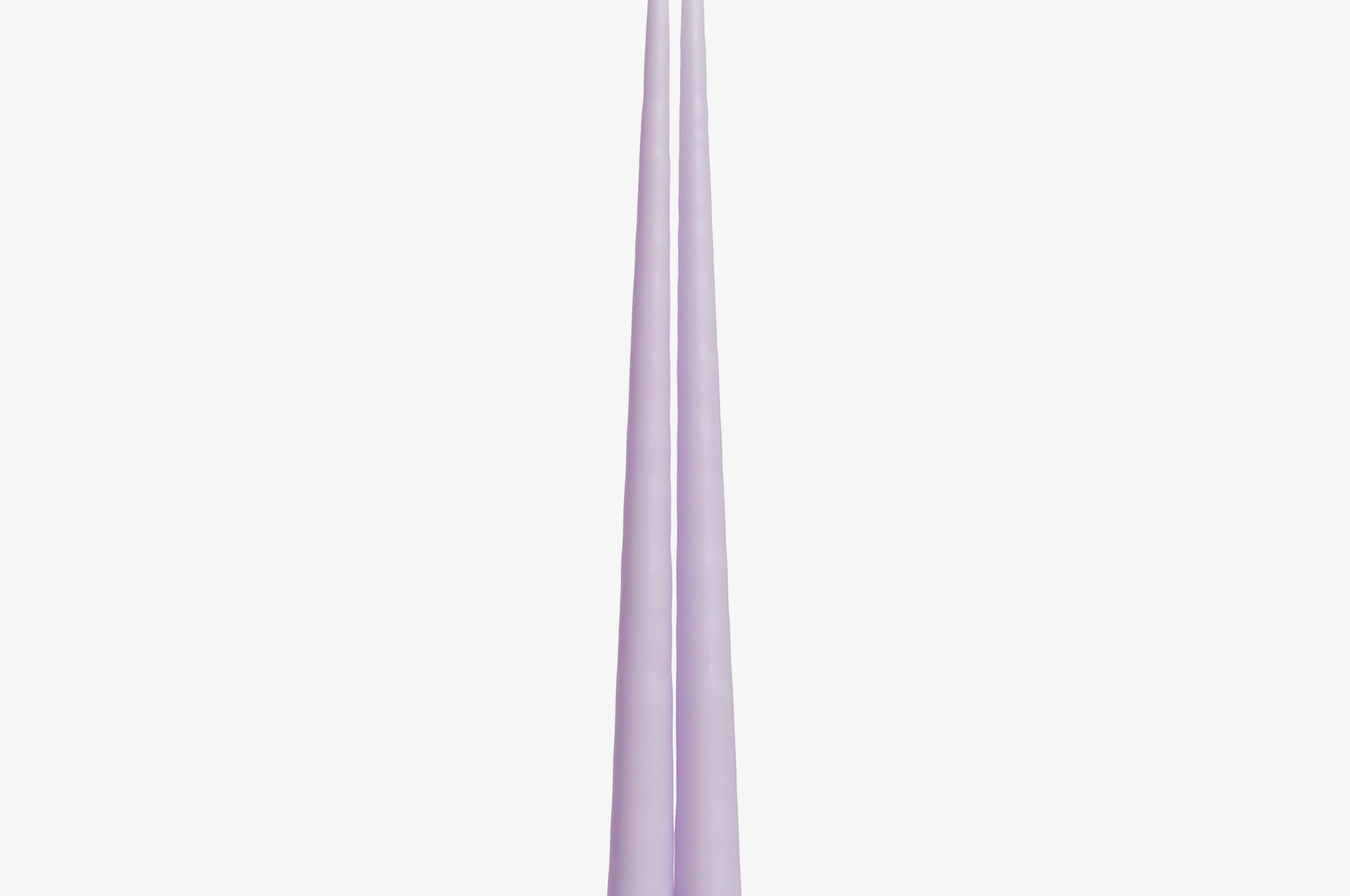 Two lavender candles on a white background