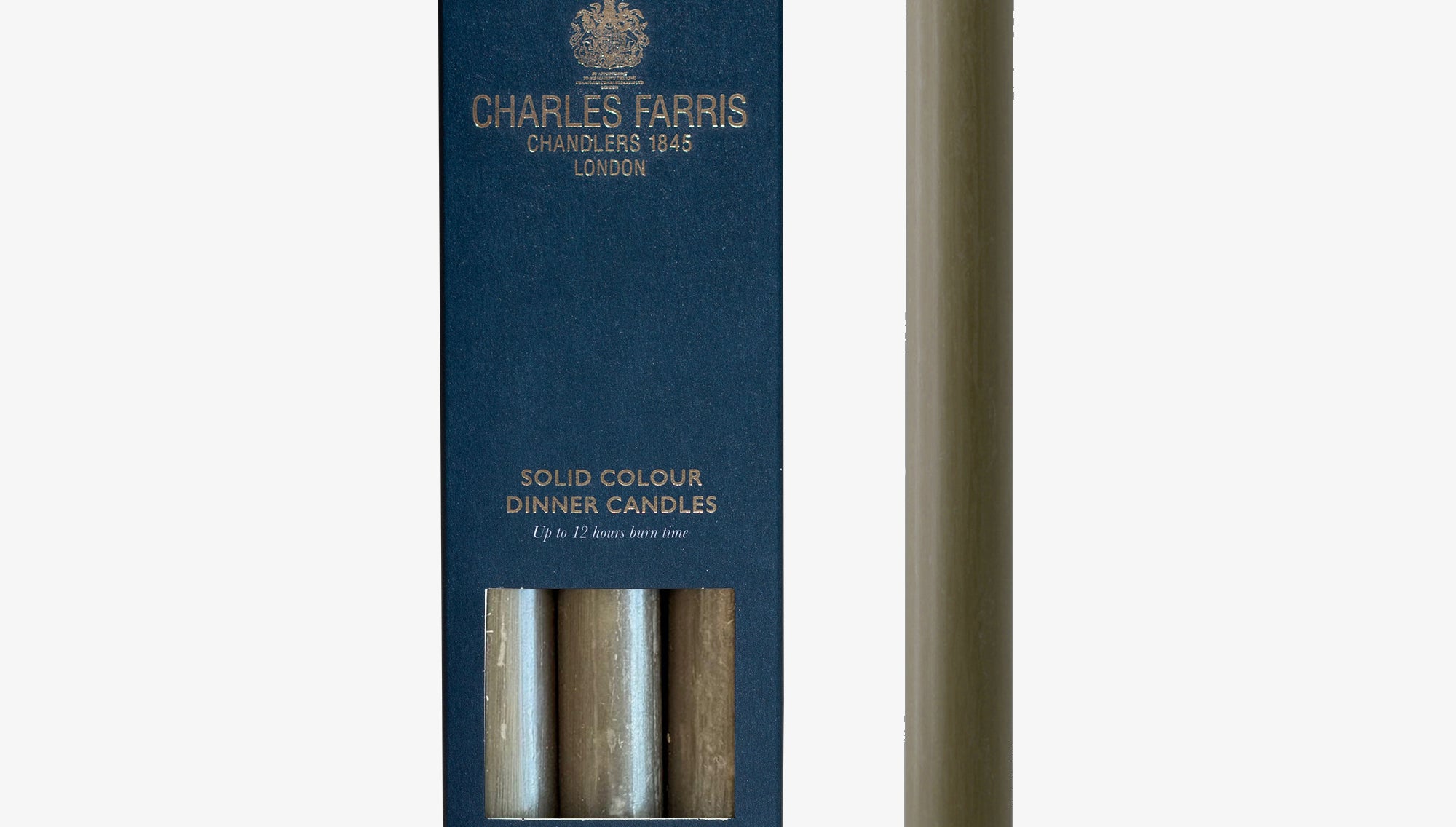 Solid color dinner candle with packaging by Charles Farris on a white background