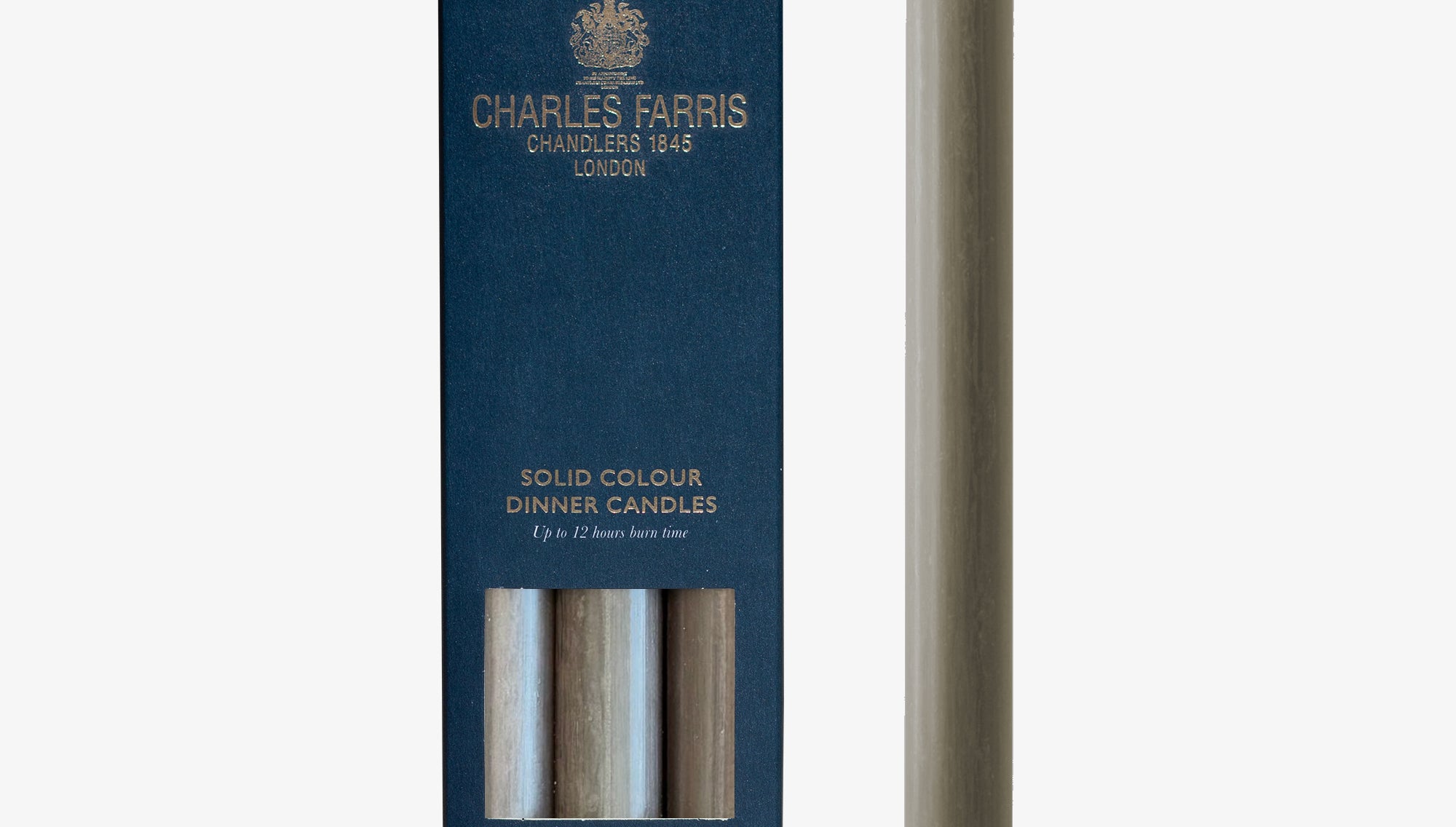 Manor House Grey solid colour dinner candle next to its packaging with 'Charles Farris' branding on a white background.