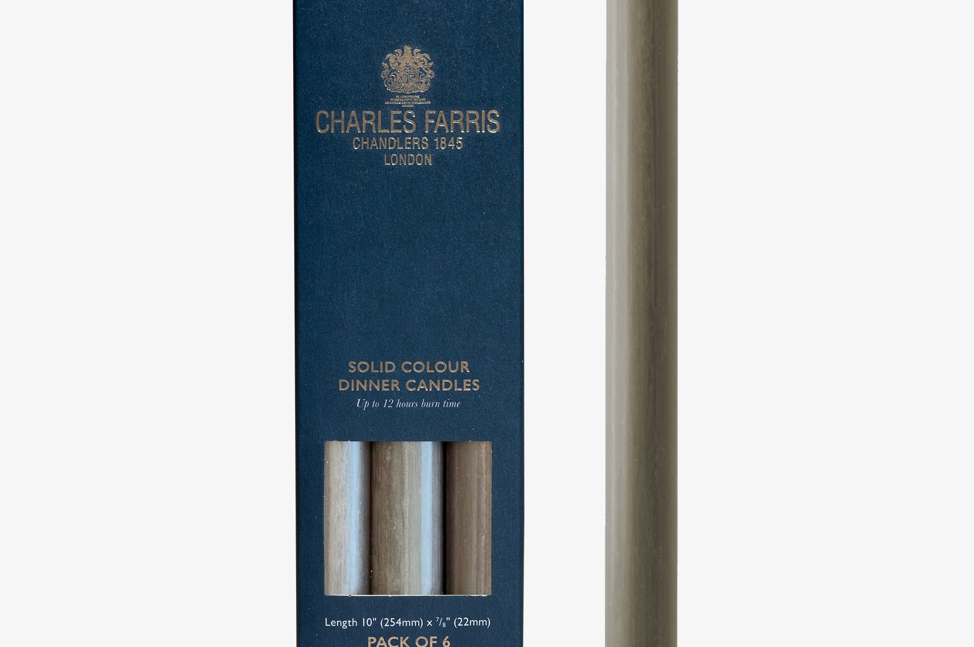 Manor House Grey solid colour dinner candle next to its packaging with 'Charles Farris' branding on a white background.