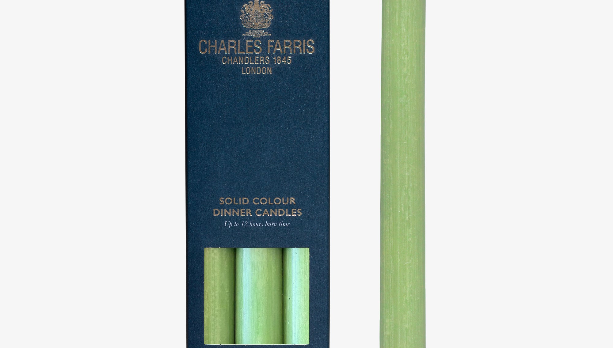 Green dinner candle with packaging displaying 'Charles Farris' branding on a white background