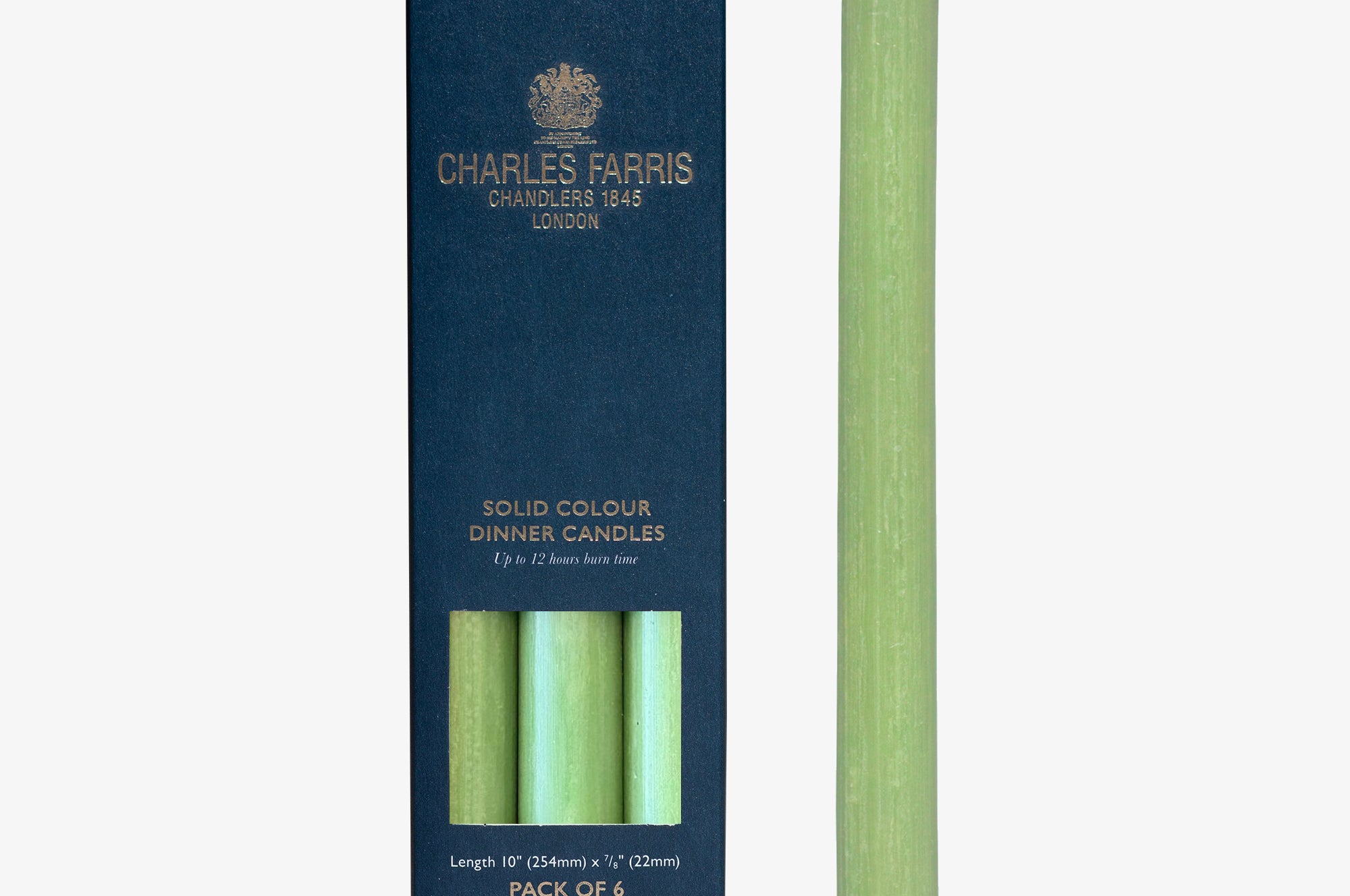 Green dinner candle with packaging displaying 'Charles Farris' branding on a white background