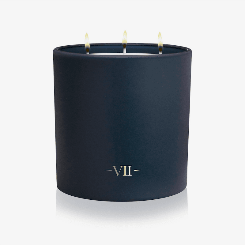 Dark blue candle with 'VII' logo on a white background