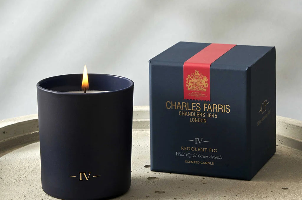 Charles Farris candle and packaging on a textured surface with a neutral background