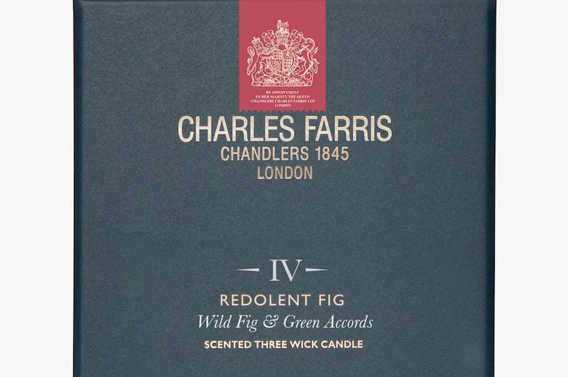 Blue box of Charles Farris candle with red ribbon and brand logo