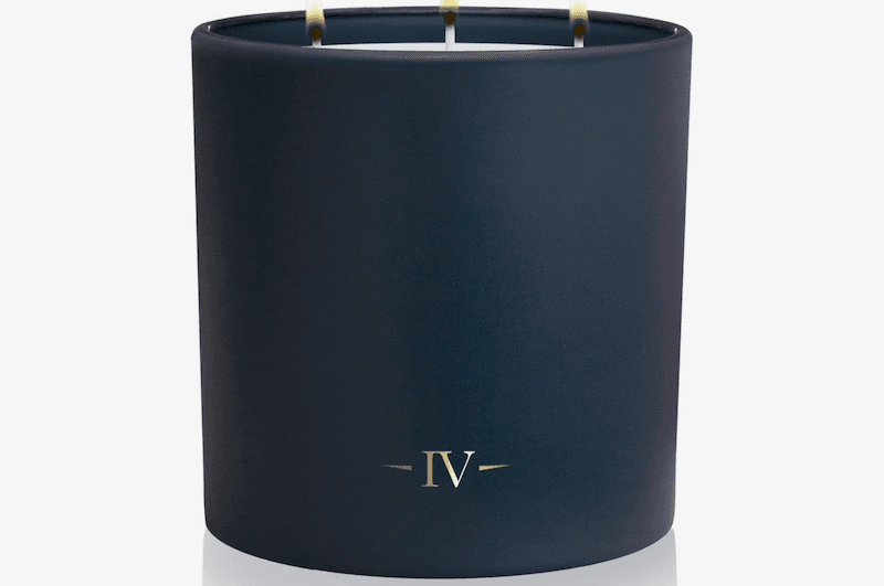 Navy blue candle with 'IV' logo on a white background