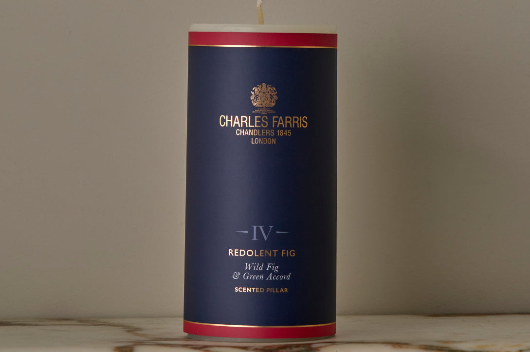 Candle with a blue and red label on a marble surface