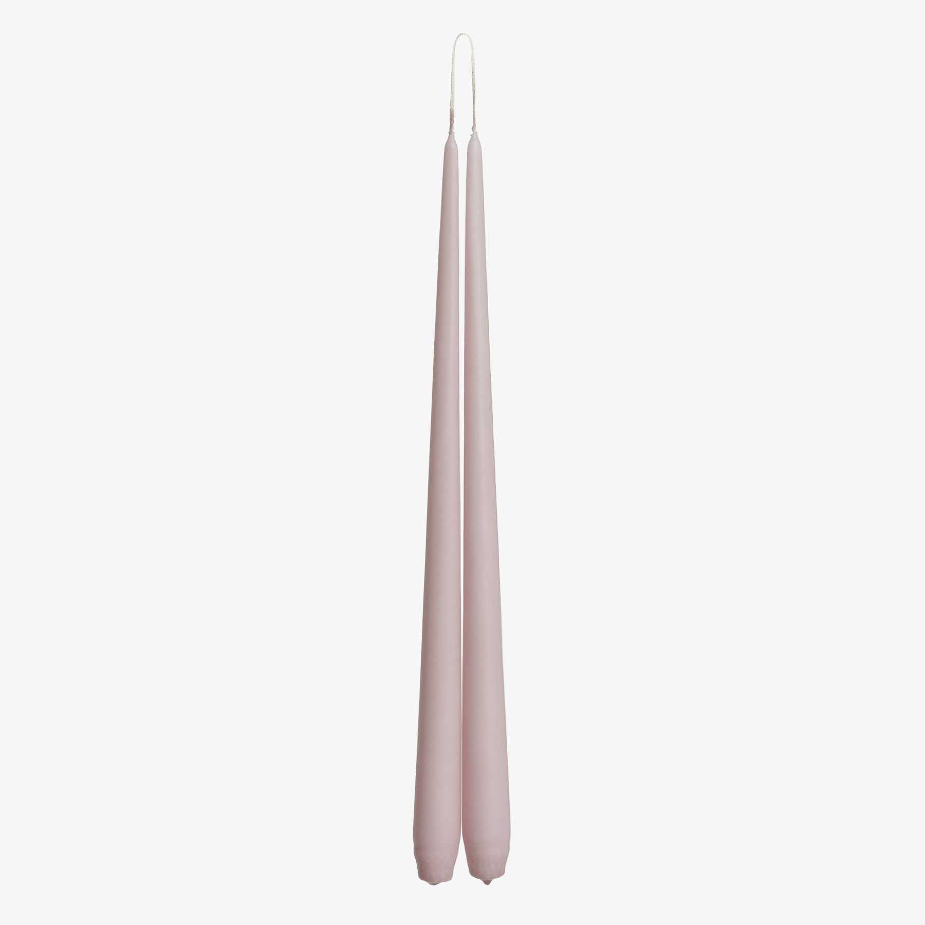 Two tall, thin, light pink candles on a white background
