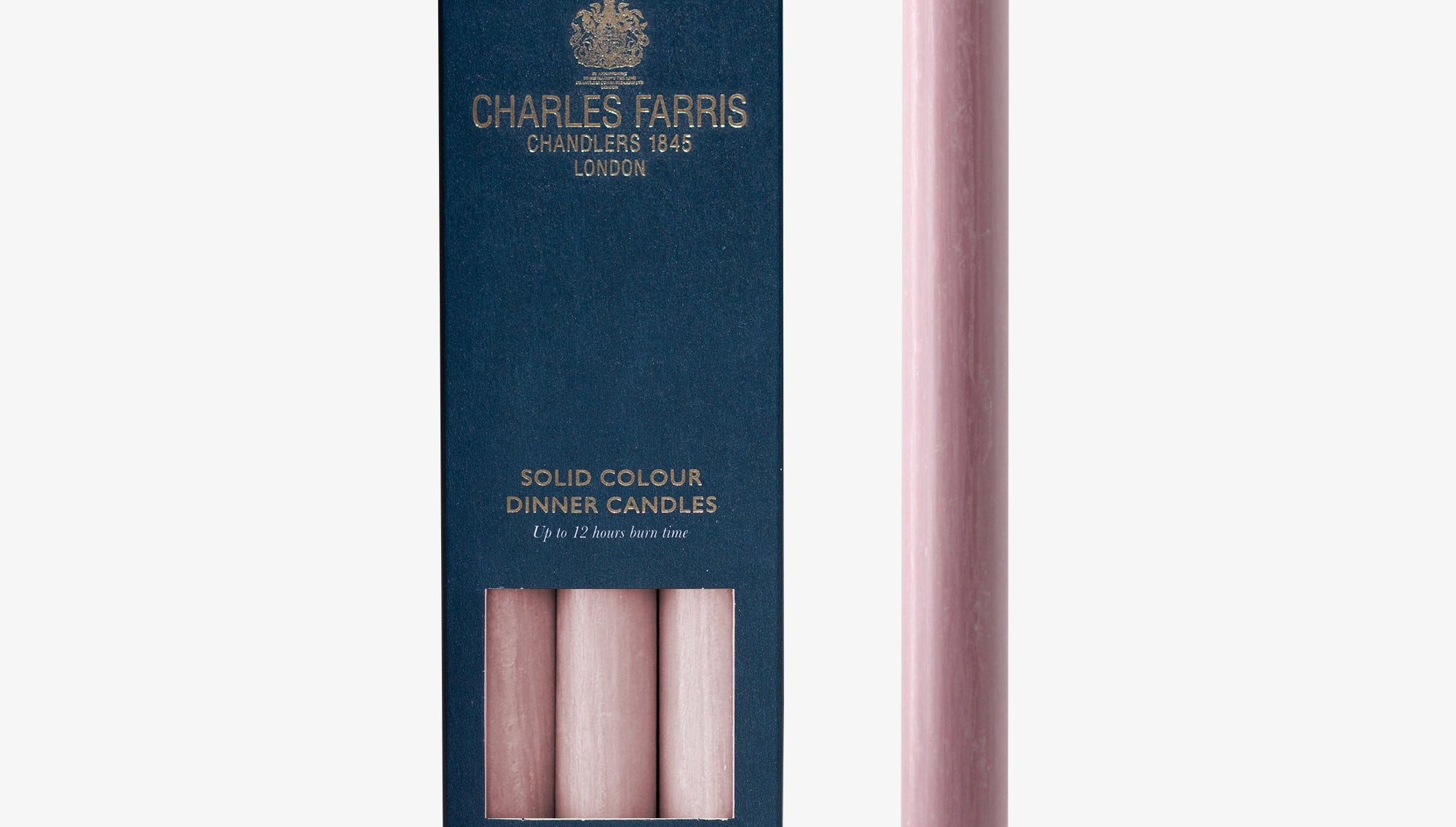 Pink dinner candle with Charles Farris packaging on a white background