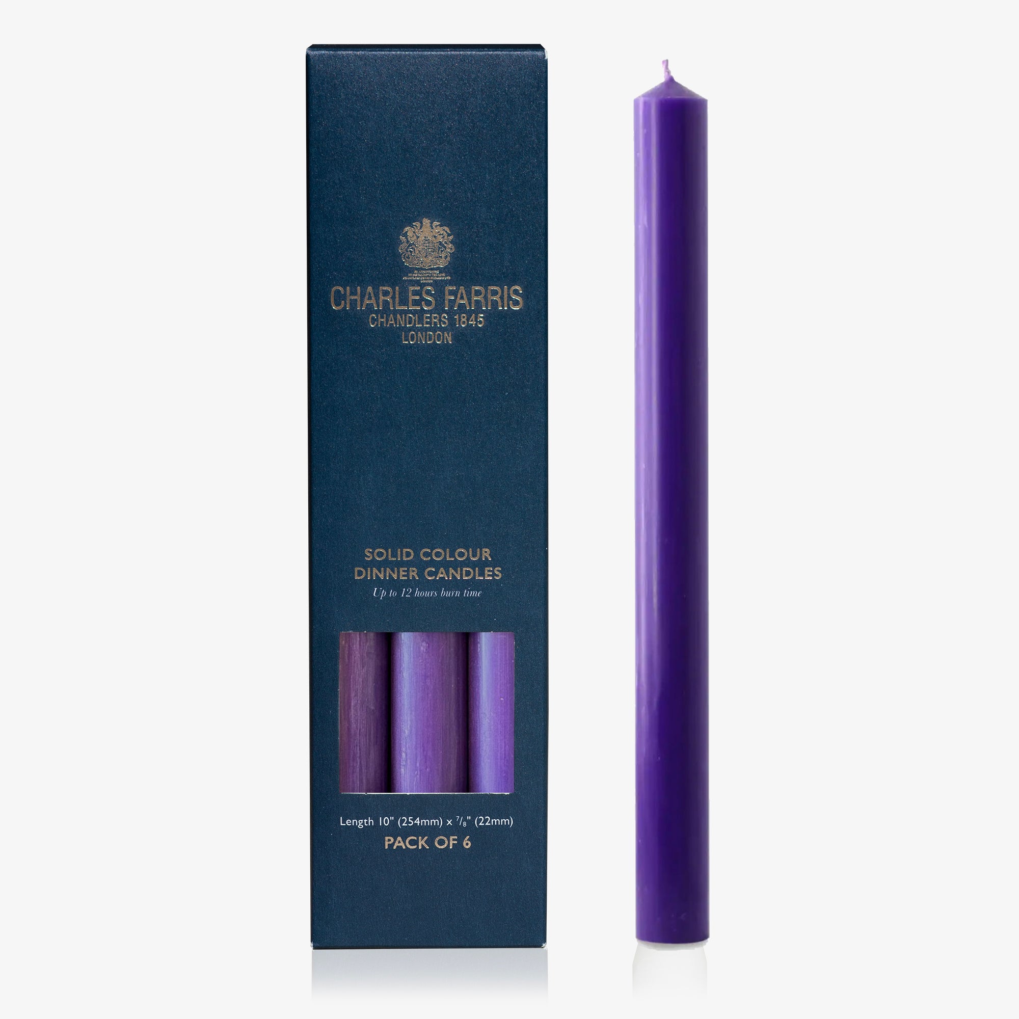 Purple candle next to its packaging with 'Charles Farris' branding on a white background