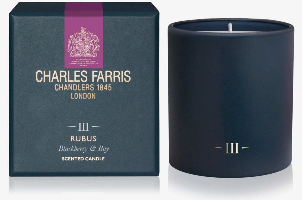 Navy blue candle with 'Charles Farris' packaging on a white background