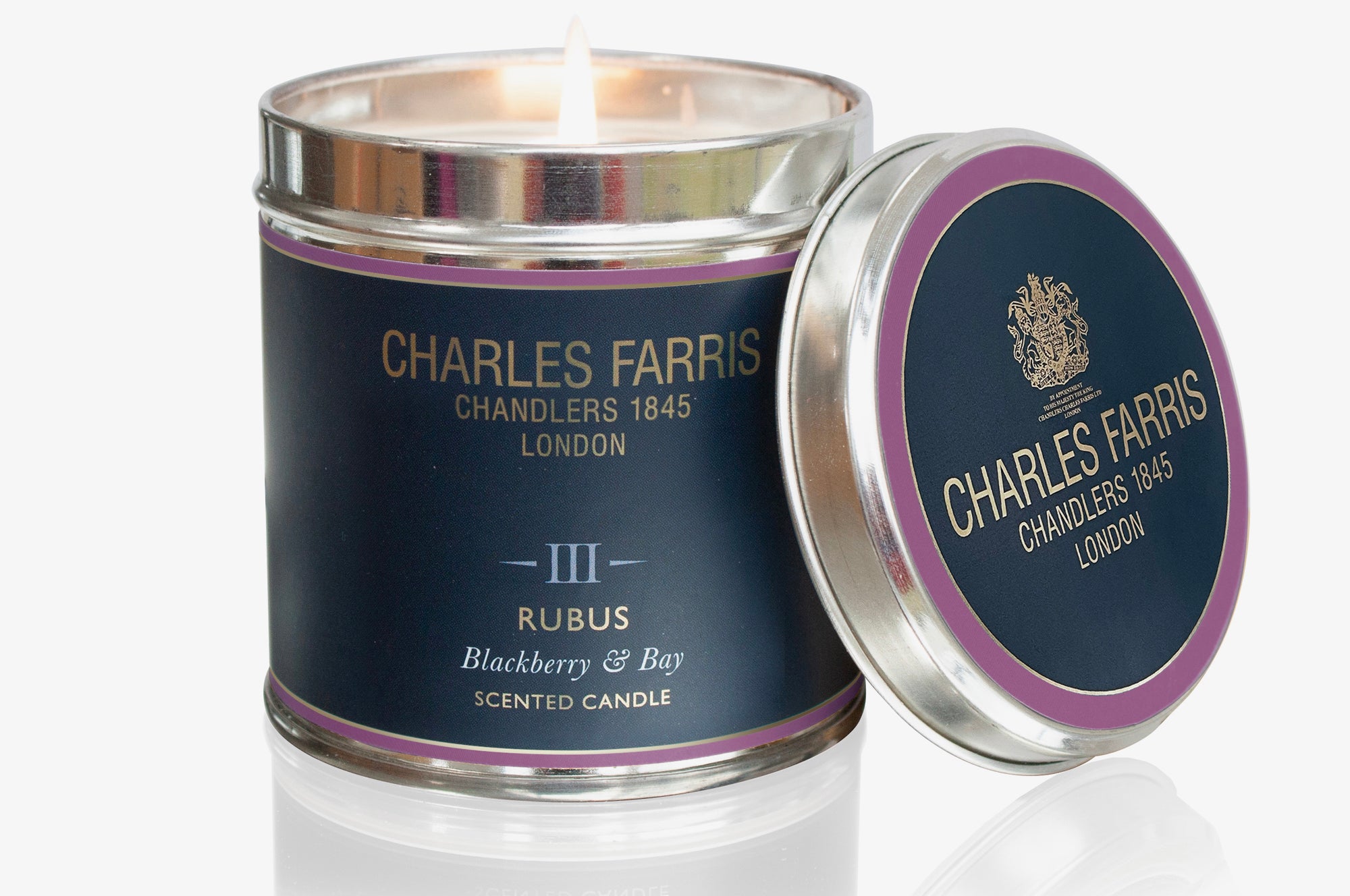 Charles Farris Rubus candle with a visible flame on a white background