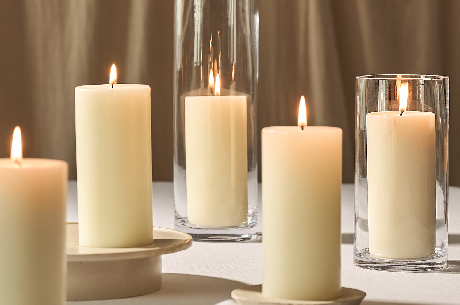A collection of lit scented pillar candles