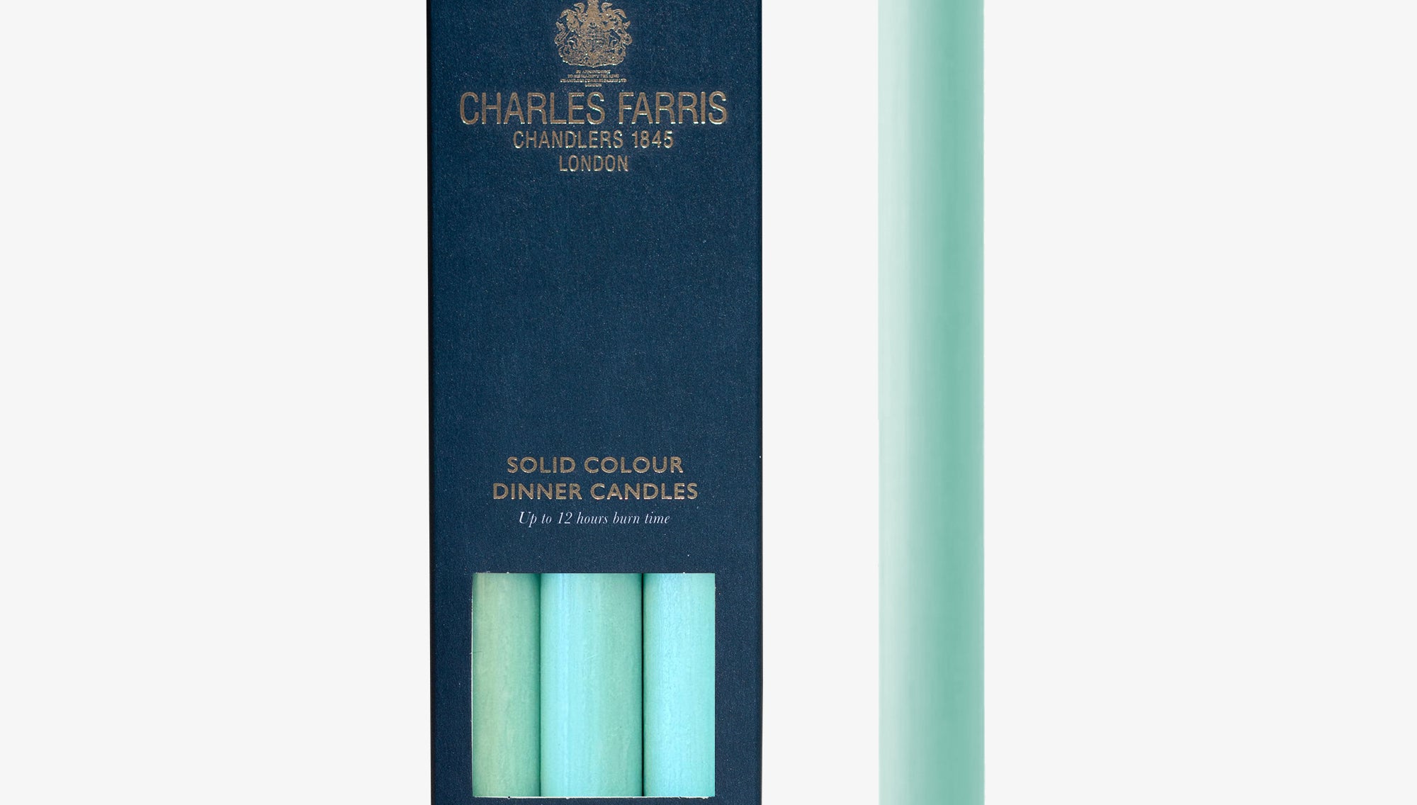 Mint green candle next to its packaging with 'Charles Farris' branding on a white background