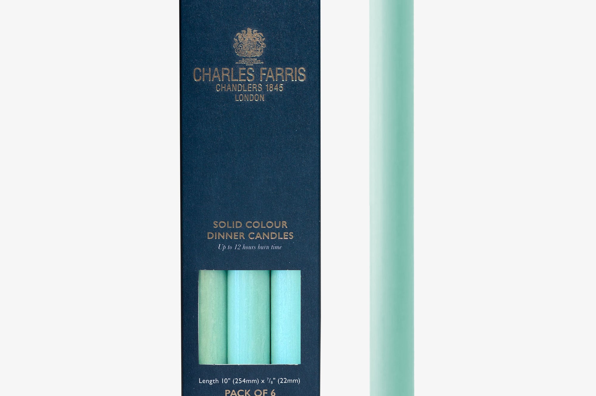 Mint green candle next to its packaging with 'Charles Farris' branding on a white background