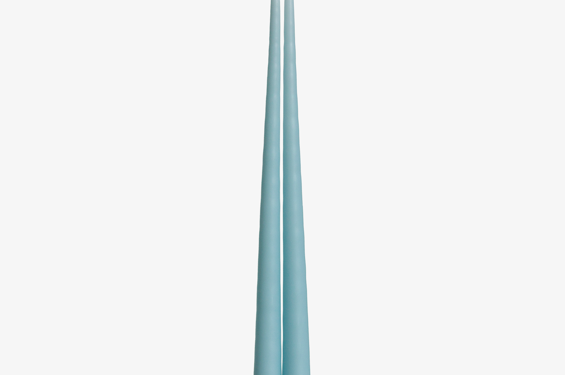 Two light blue candles on a white background