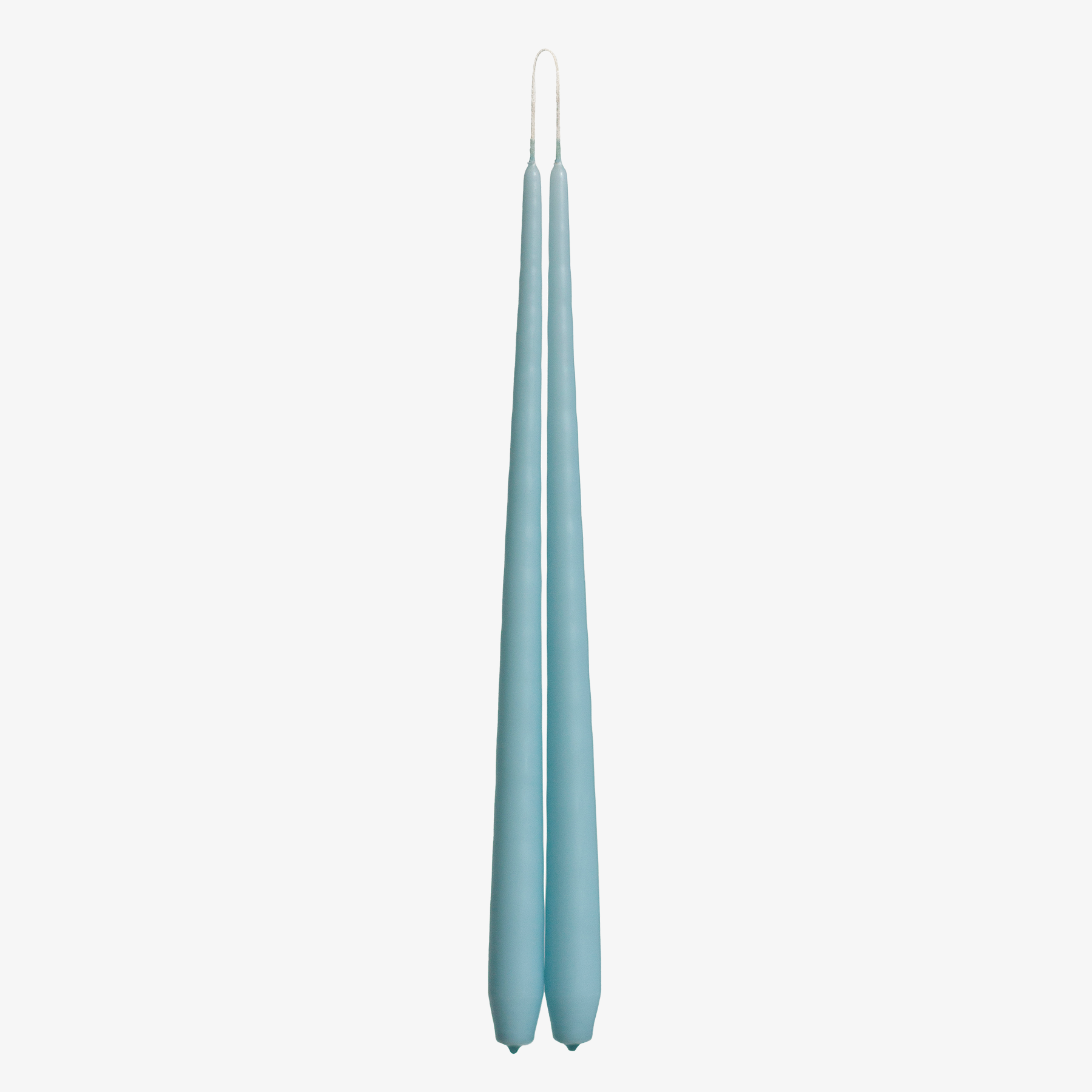 Two light blue candles on a white background