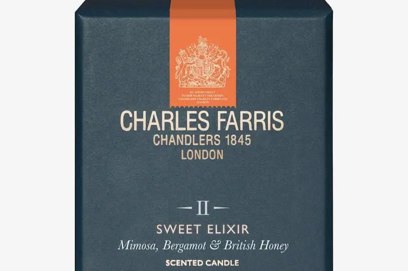 Charles Farris scented candle box with an orange ribbon on a white background