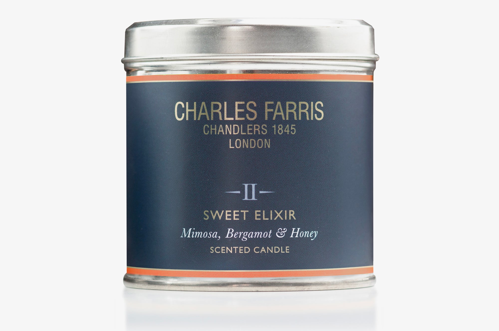 Sweet Elixir scented candle tin labeled 'Charles Farris' on a white background