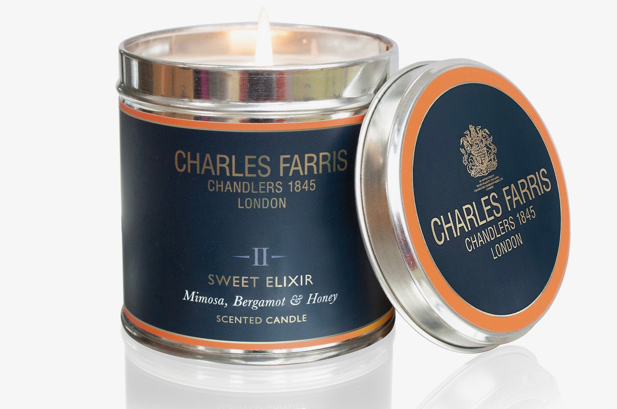 Charles Farris Sweet Elixir scented candle with lid open on a white background