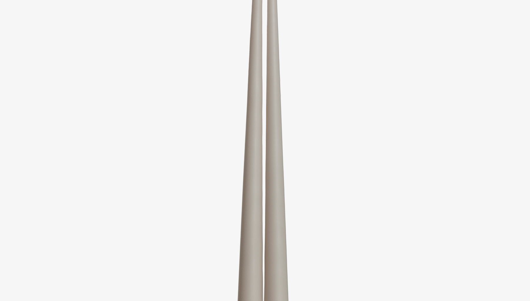 Two grayish brown candles on a white background