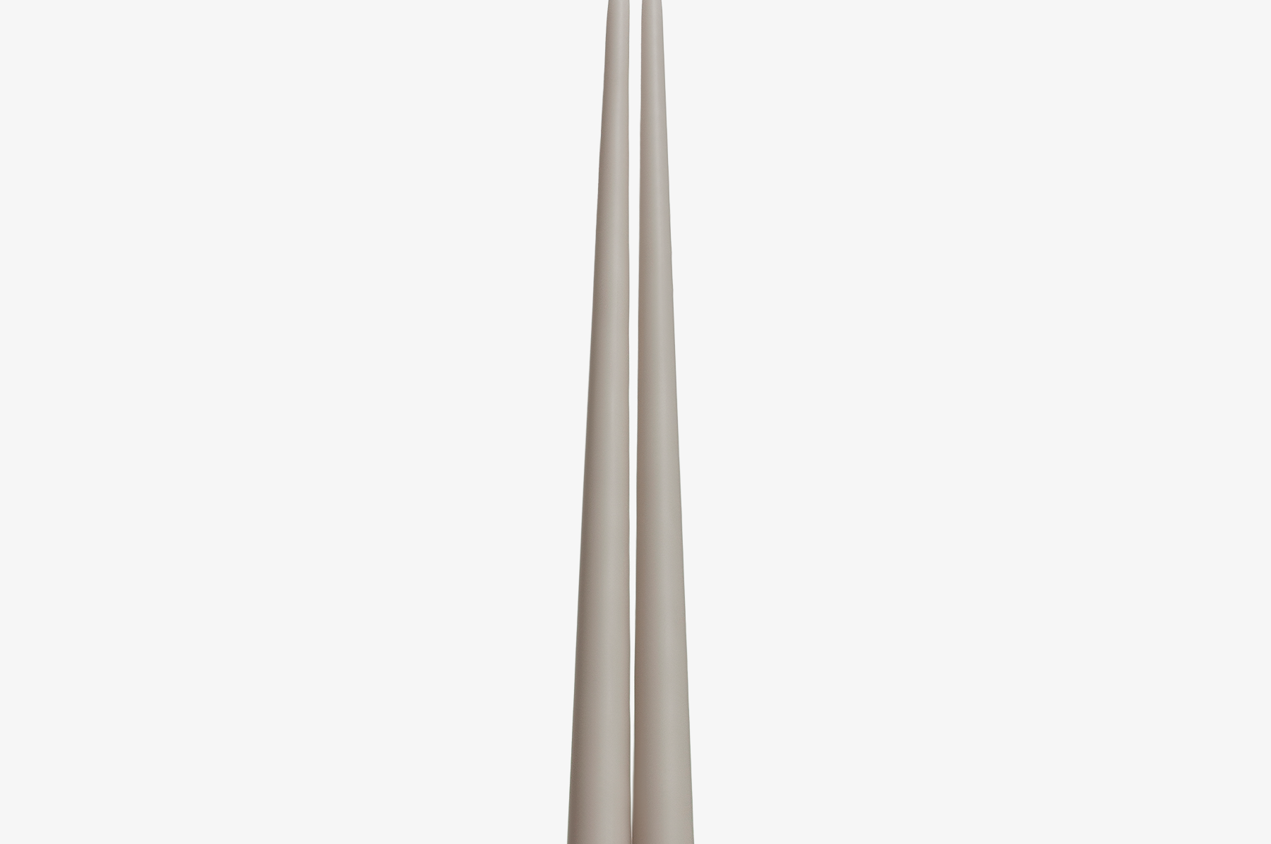 Two grayish brown candles on a white background