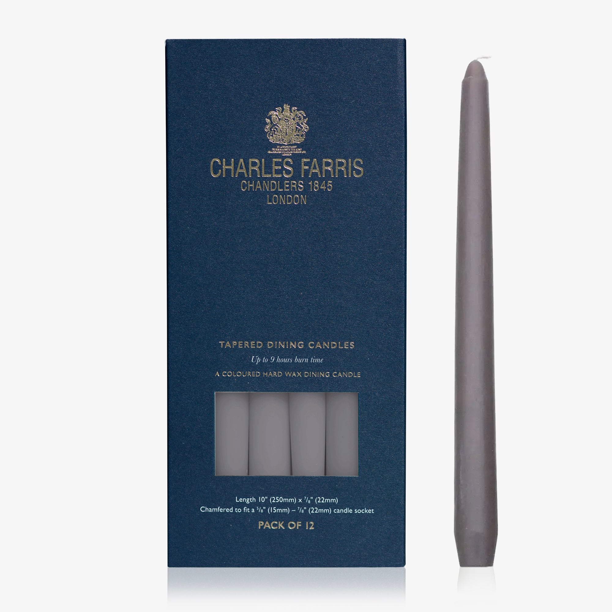 Dark gray taper candle next to its packaging with 'Charles Farris' branding on a white background