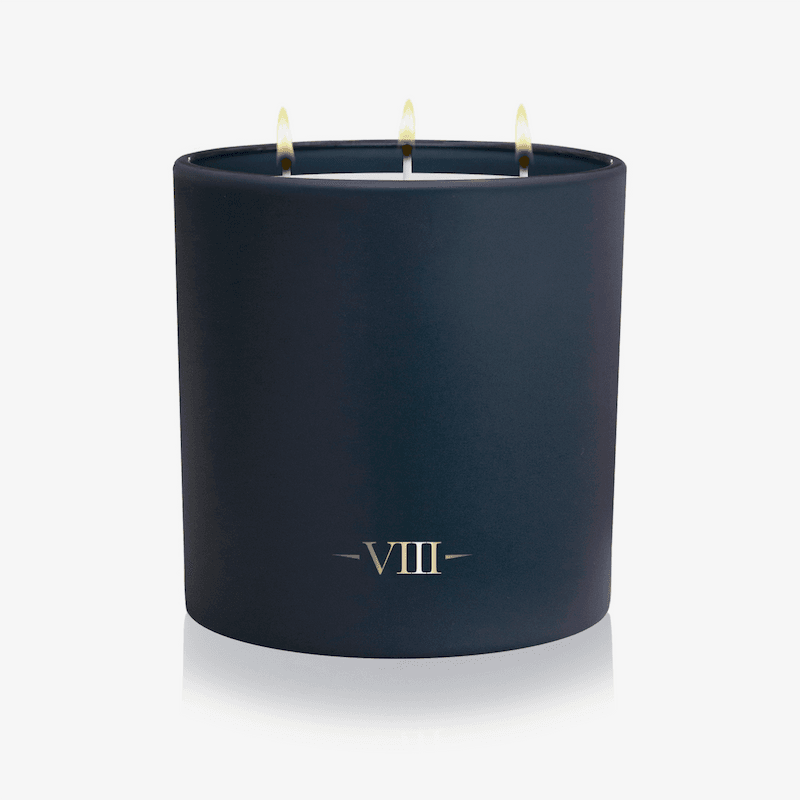 Navy blue candle with 'VIII' logo on a white background