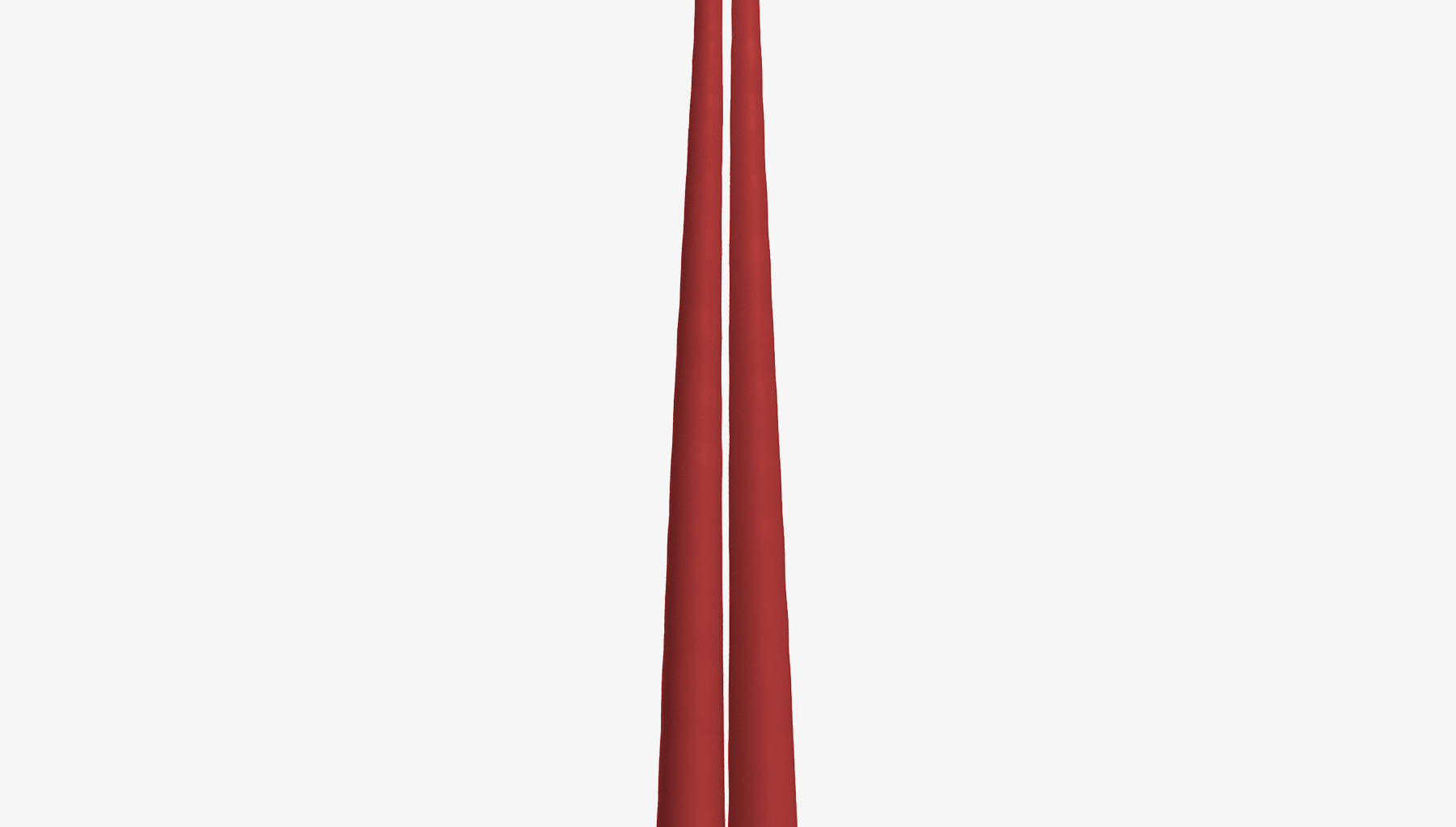 Two red candles on a white background