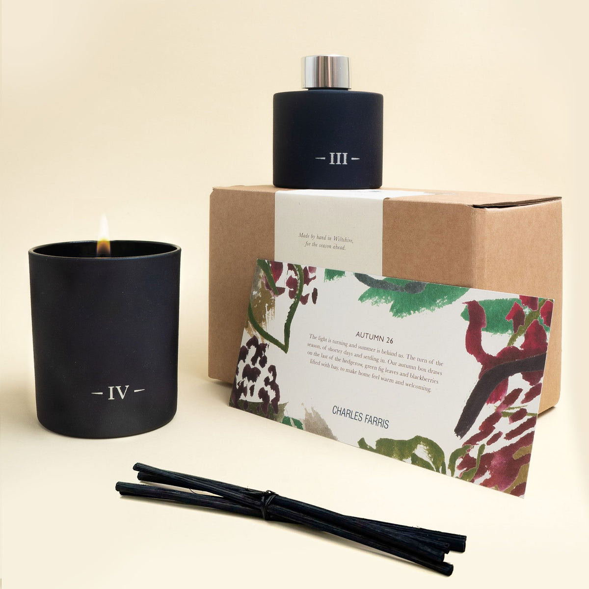 Charles Farris A Candlemaker's Year box with the Redolent Fig candle lit, the Rubus reed diffuser, reeds and seasonal note card
