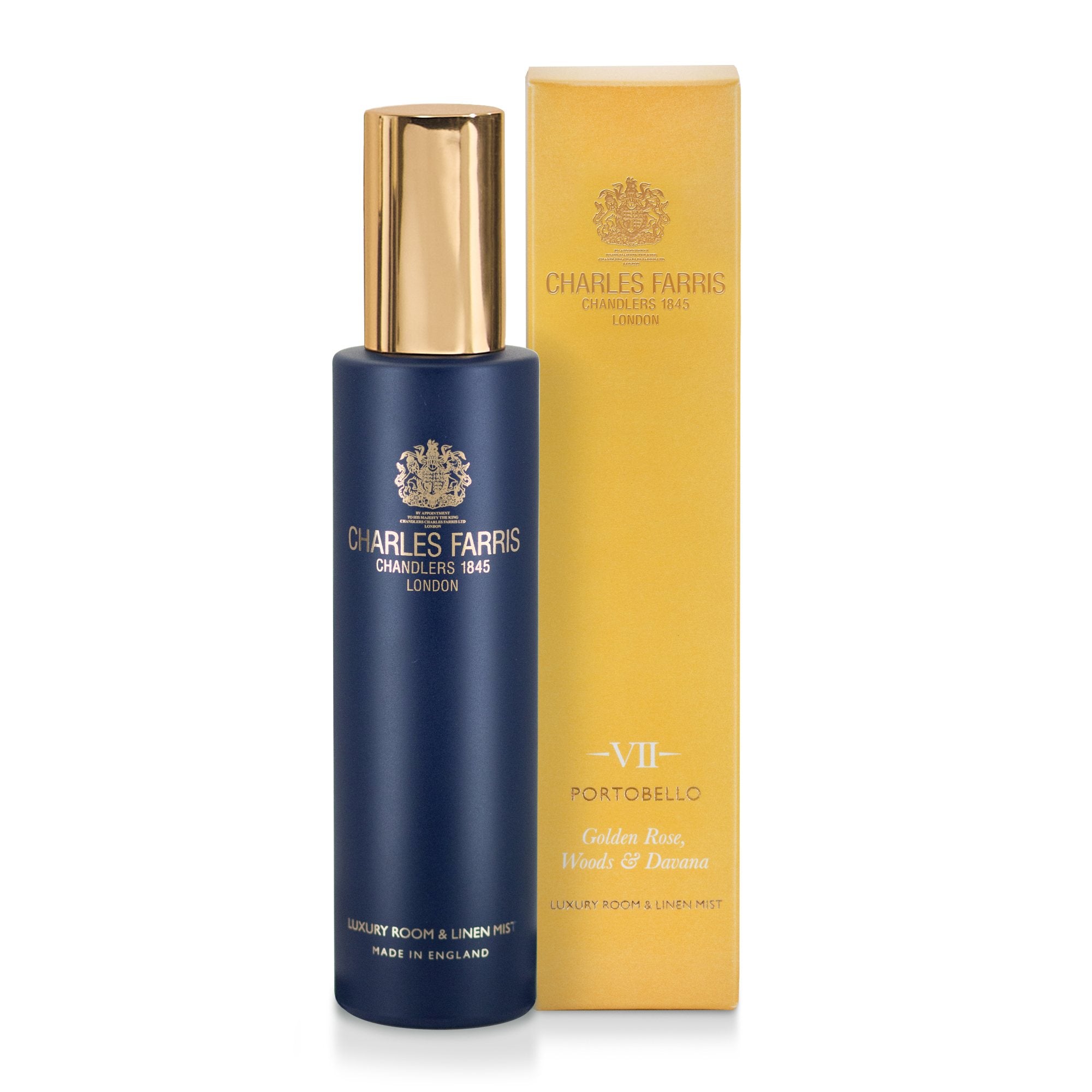 Charles Farris Portobello rose and oak room mist scented home spray in navy blue bottle next to its yellow packaging.