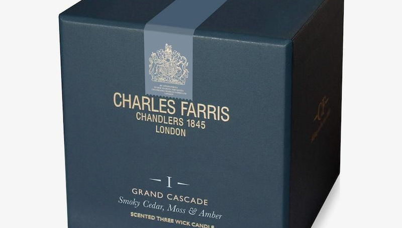 Blue box of Charles Farris candle with branding and product details on a white background