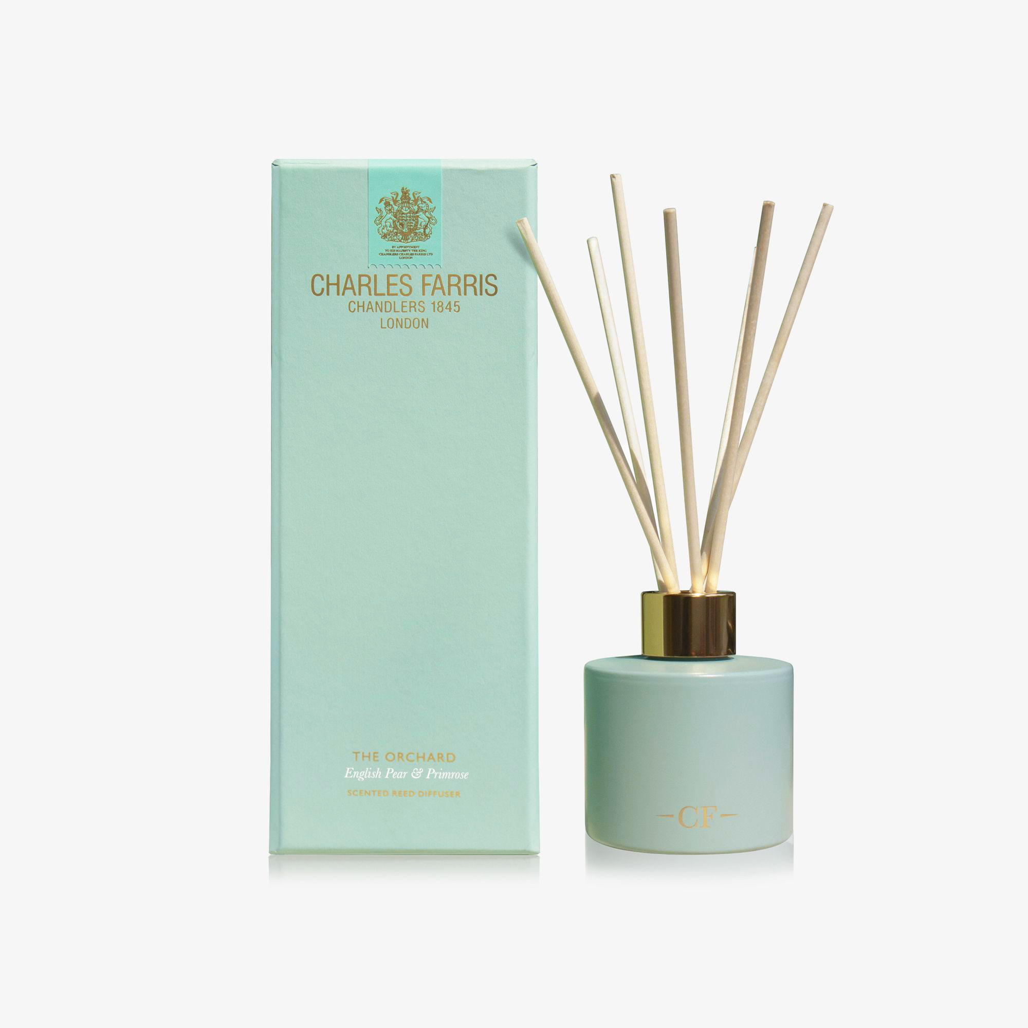 Mint green diffuser bottle with wooden sticks and matching box labeled 'Charles Farris' on a white background